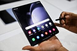 A promoter shows a Samsung Galaxy Z Fold5 phone during the Samsung Galaxy Unpacked 2023 event