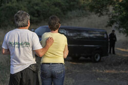 An Alameda County couple watches as investigators prepare to retrieve the body of Nina Reiser in the Oakland hills in July 2008