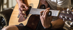 guy playing acoustic guitar