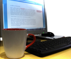 Drinking coffee while typing a text in Microsoft Word.