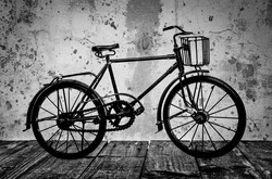 Old rusty vintage bicycle near the concrete wall - black and white