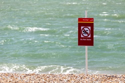 Do not swim sign on a beach