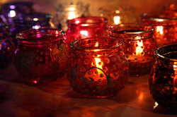 Lit candles in colorful oriental candle holders