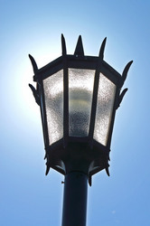 Sun behind a lamp post