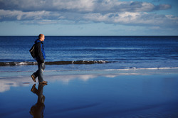 Young man walking on the beach