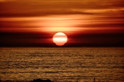 Bright orange sunset over Pacific Ocean in Santa Monica, California