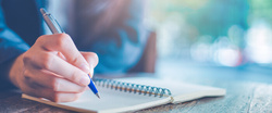 a persons hand doing note-taking