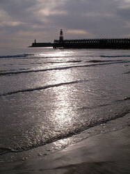 Newhaven harbour back lit vertical landscape with stormy sky. 