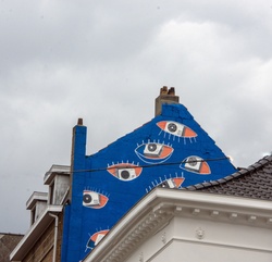 Bright modern abstract eyeballs painted on the side of a building