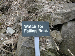 A sign warning of the danger of falling rocks 