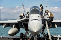 Sailors conduct routine maintenance on a fa-18f super hornet assigned to the blacklions of strike fighter squadron vfa 213 aboard the aircraft carrier uss george h.w. bush cvn 77.