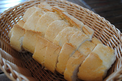 The bread was sliced and placed into a basket.