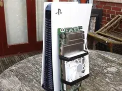 PlayStation 5 console placed beside a custom-built AMD BC250 board