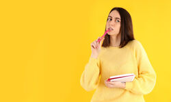 a lady with a pen in the mouth