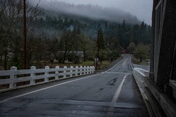 Emerging from a bridge onto a damp country road in the snow
