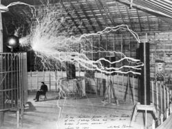 A double-exposed photograph showing Tesla in his Colorado Springs laboratory