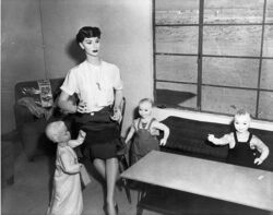 Mannequin woman and three mannequin children in living room