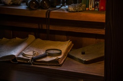 Desk with book, map, magnifying glass and binoculars