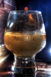 Half-full glass of beer with condensation
