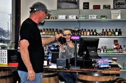 Man Buying Bottle Of Liquor