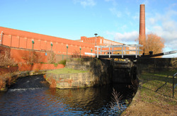 A factory chimney and a canal in Manchester