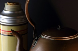 Vintage copper kettle with old thermos flask
