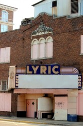 A desolate dilapidated abandoned movie theater. All run down, and in ruins. This theater has seen better days.