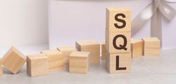 sql letters wooden cubes concept white gift box background