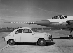 SAAB 93B car with Airplane Unknown Photographer Public Domain