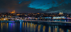 Bridge full of lights and buildings at the background