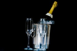 Two glasses of champagne with a champagne bottle in a bucket