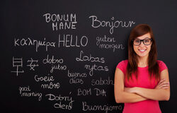 a lady standing next to the board with many word translation