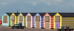Row of colorful wooden beach huts