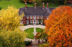 Huge mansion with colorful trees in autumn