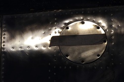 Letter work preserved by masking during metal polishing process on an aircraft