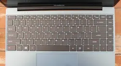 The keyboard features a QWERTY keyboard, a touchpad, and three LEDs