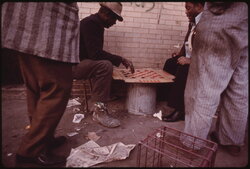 South side Black workers passing the time playing checkers on East 35th Street before...